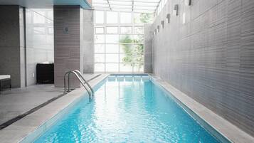 Indoor pool, open 9:00 AM to 9:00 PM, pool loungers