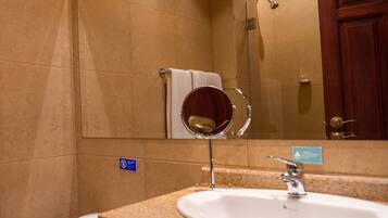 A bathroom with a sink, mirror, and toilet.