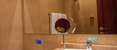 A bathroom with a sink, mirror, and toilet.
