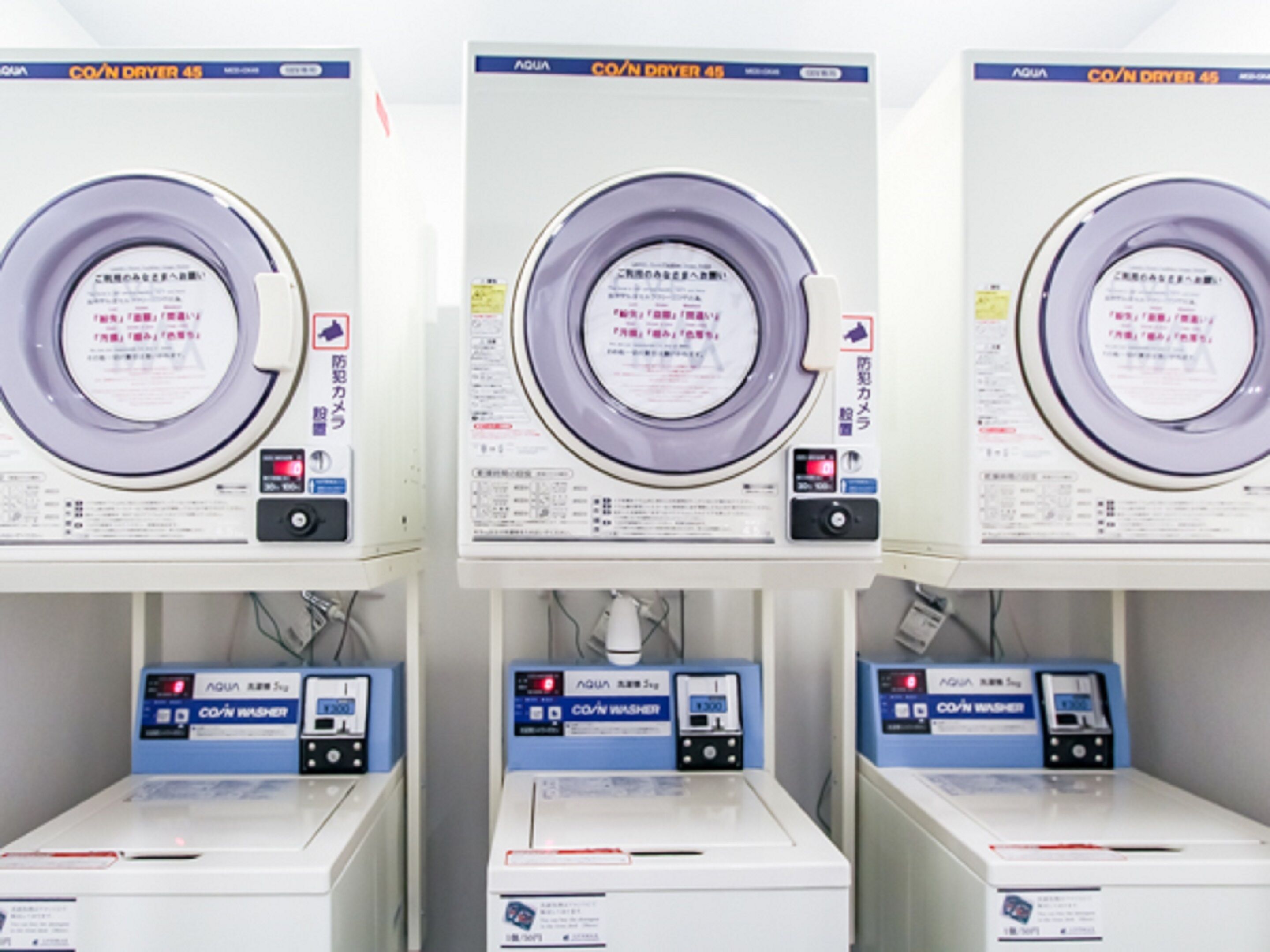 Three rows of identical machines with labels in a foreign language, likely indicating a specialized facility or equipment.
