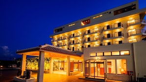A multi-story hotel with a covered entrance and balconies. - Lit Hotel NAKIJIN (Nakijin)