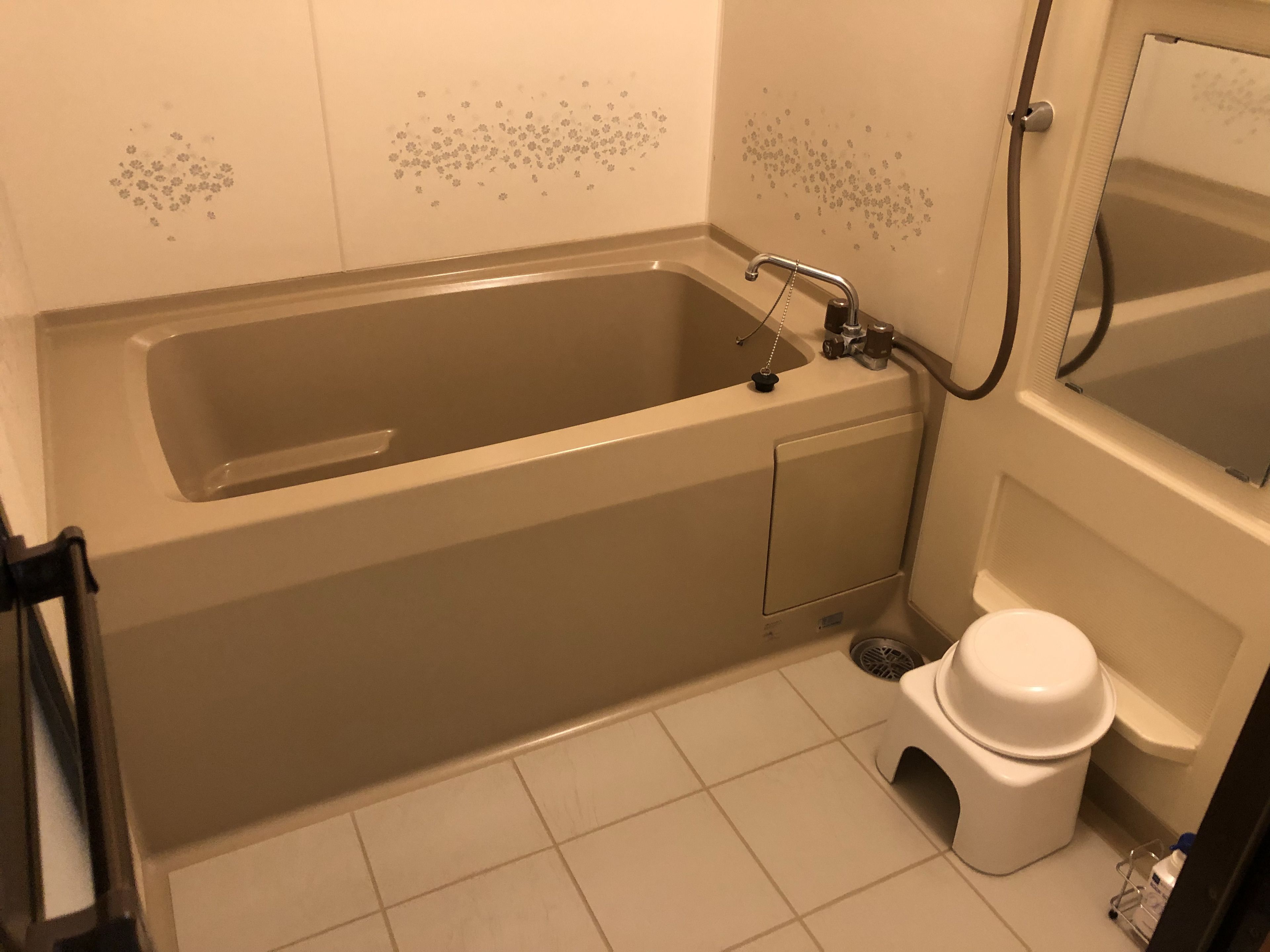 A bathroom with a bathtub, toilet, and a shower.
