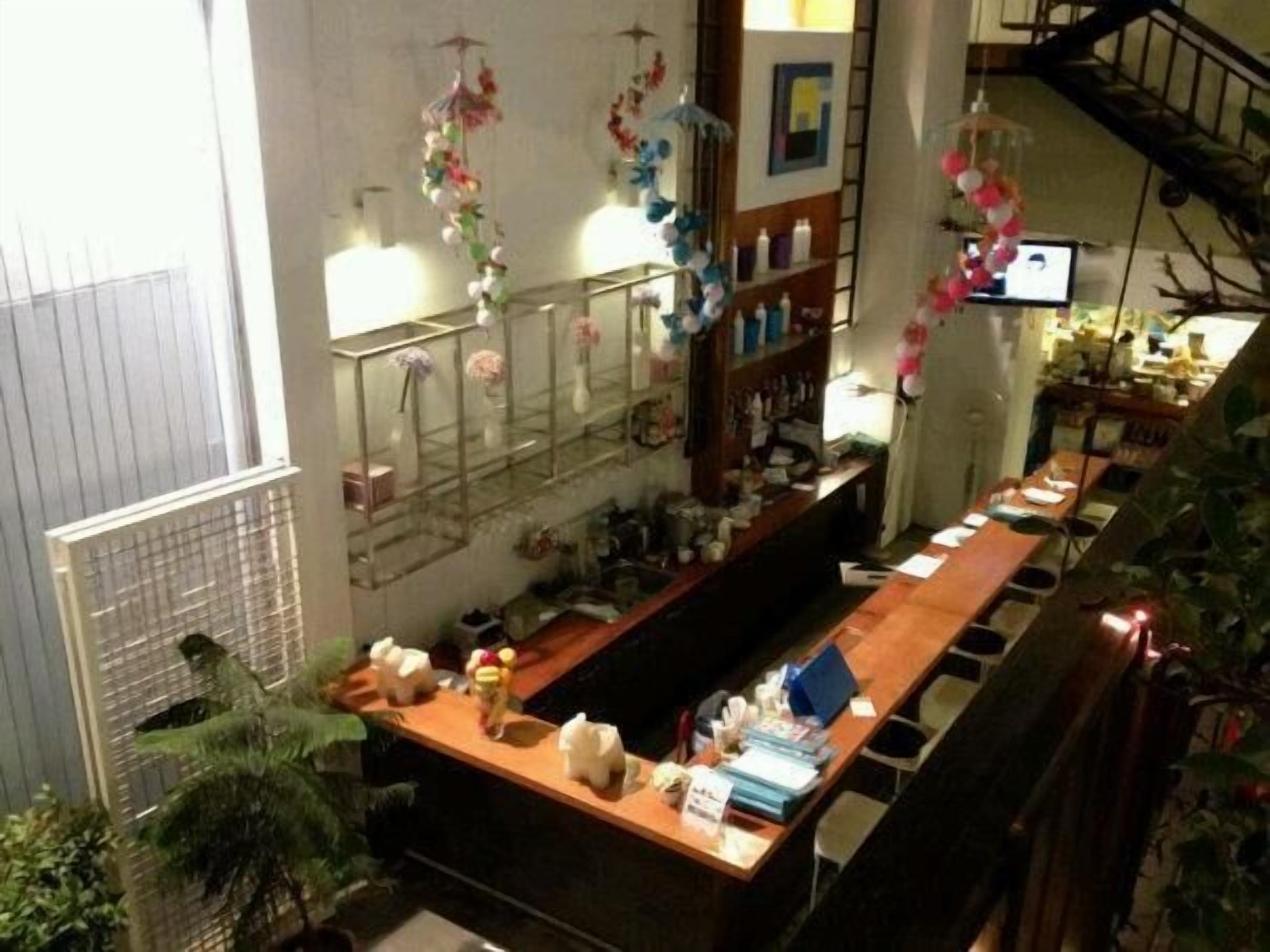Eine Bar mit einer Theke, Regalen voller Flaschen und einer Treppe.