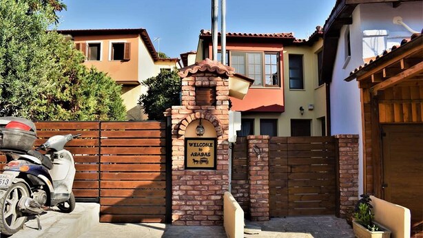 A gated entrance with a sign welcoming visitors to a property. - Arabas - Hostel (Thessaloniki)