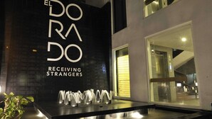 A modern building with a sign reading "EL DORADO RECEIVING STRANGERS".