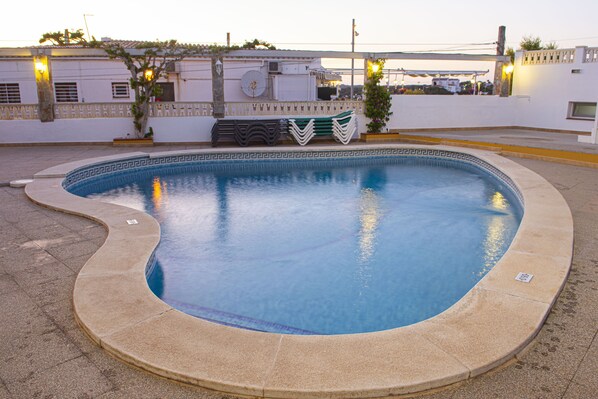 Seasonal outdoor pool, open 9:00 AM to 9:00 PM, pool umbrellas