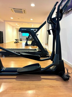 Stay active with a fully equipped fitness room featuring a stationary bike and treadmill.