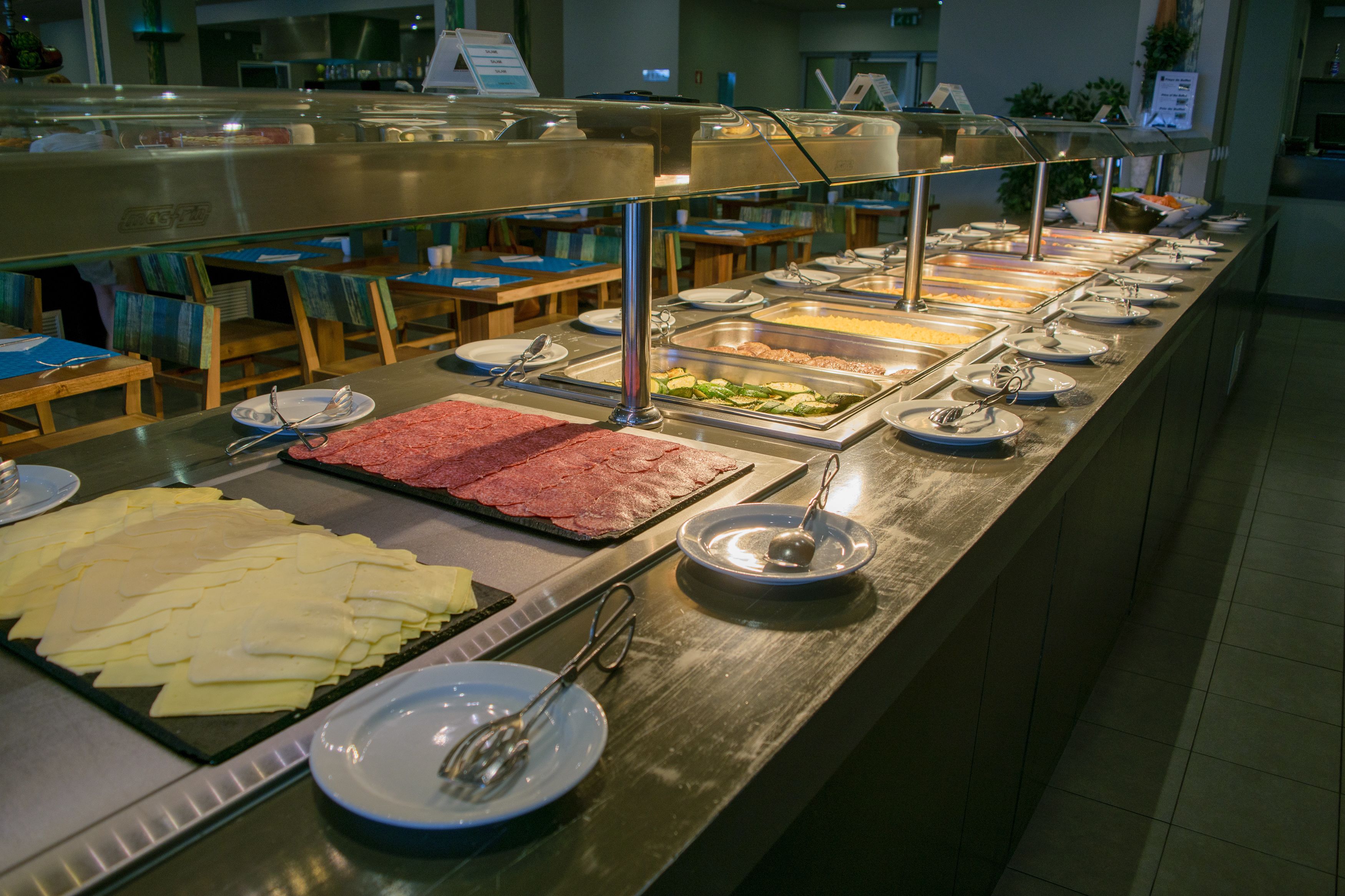 Un buffet proposant une variété de plats et d’ustensiles.