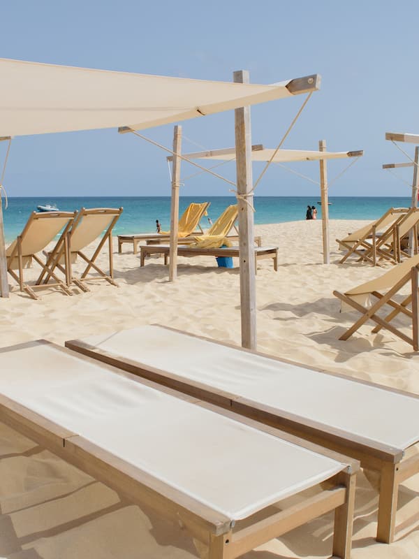 On the beach, white sand, sun loungers, beach towels