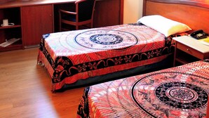 Una habitación de hotel con dos camas, un escritorio y una silla.
