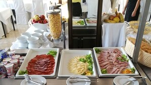A buffet table with various food items, including sliced meats, cheeses, and fruits. - Hotel Liberty (Novalja)