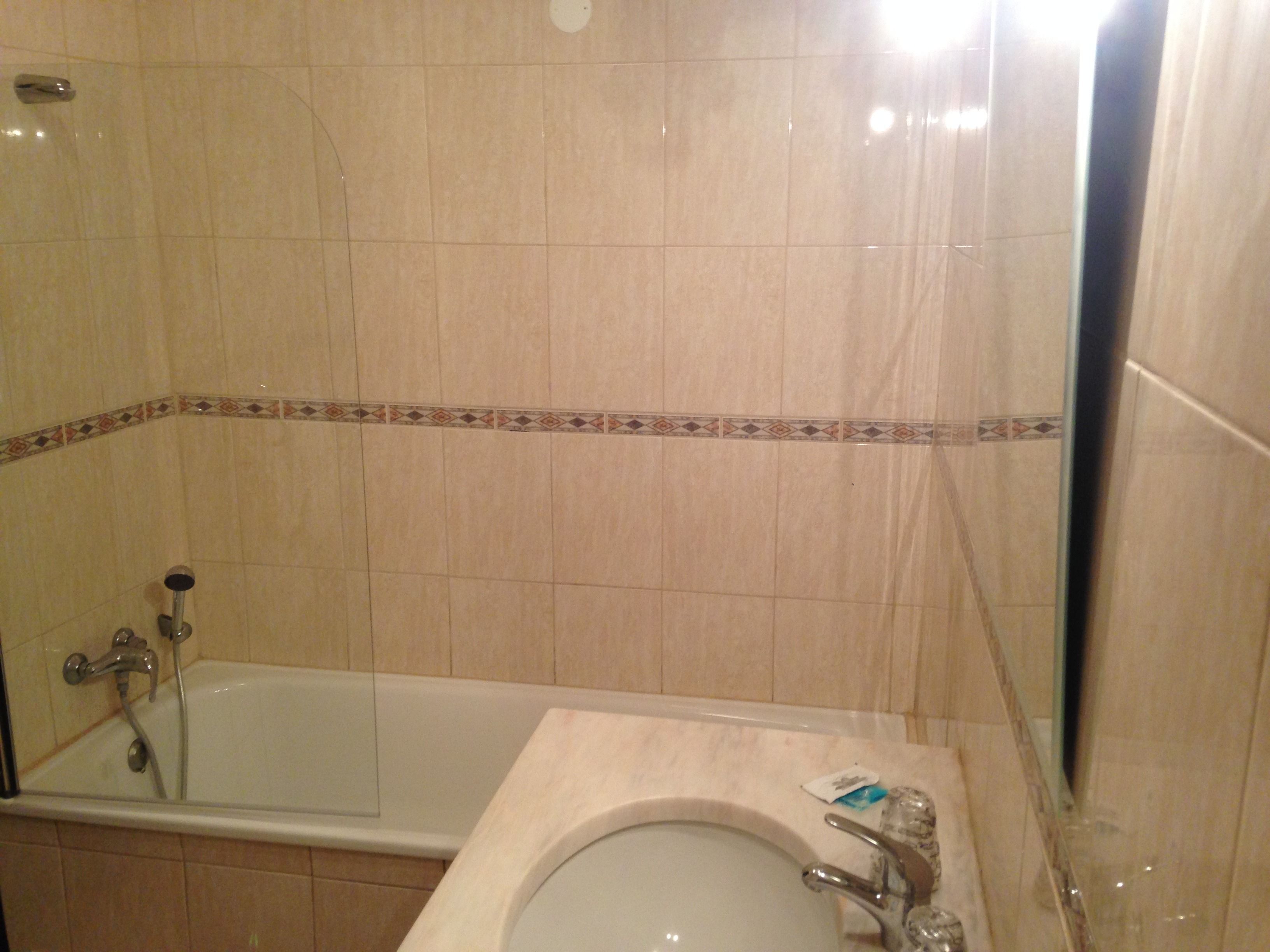 A bathroom with a bathtub, a sink, and a shower.
