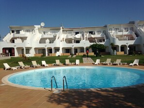 Enjoy a refreshing swim in the hotel's pool surrounded by sun loungers and a deck area.