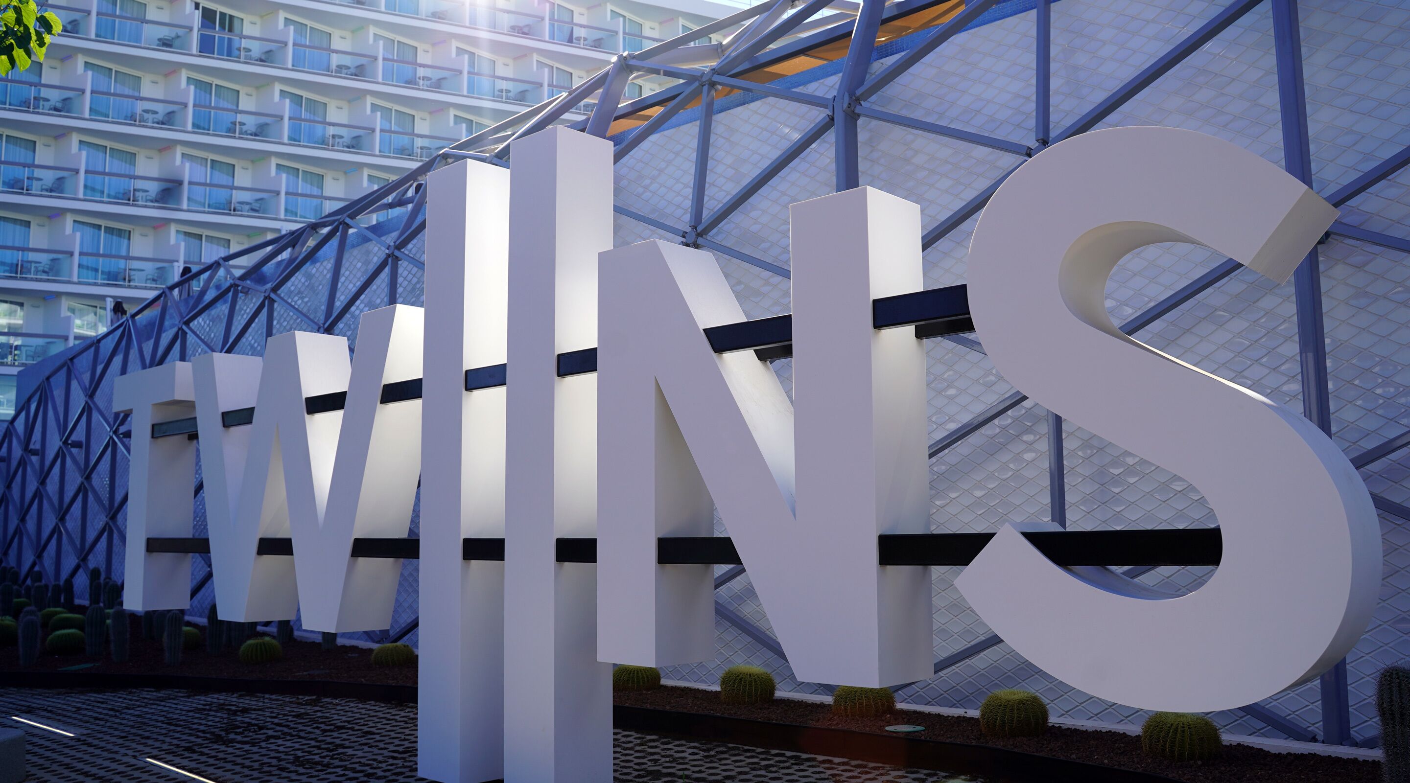 A modern building with large 'EWINS' letters and a glass facade.