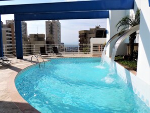 Relax by the rooftop pool with a stunning city view.