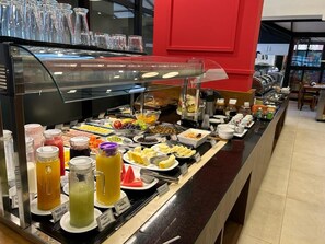 Indulge in a diverse selection of fresh fruits, salads, and prepared dishes at our buffet.