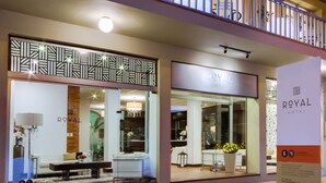 A hotel entrance with a modern design, including a patterned facade and a visible reception area. - Hotel Royal Colonia (Colonia del Sacramento)