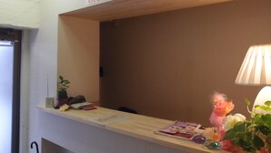 A reception desk with a sign reading "GUEST HOUSE SAKURA". - SAKURA GUEST HOUSE OSAKA DOUTONBORI - Hostel (Osaka)