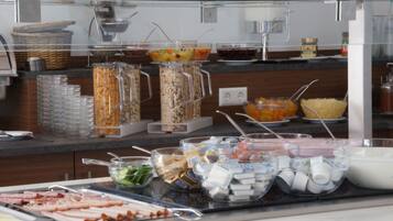 A buffet with various food items and condiments.