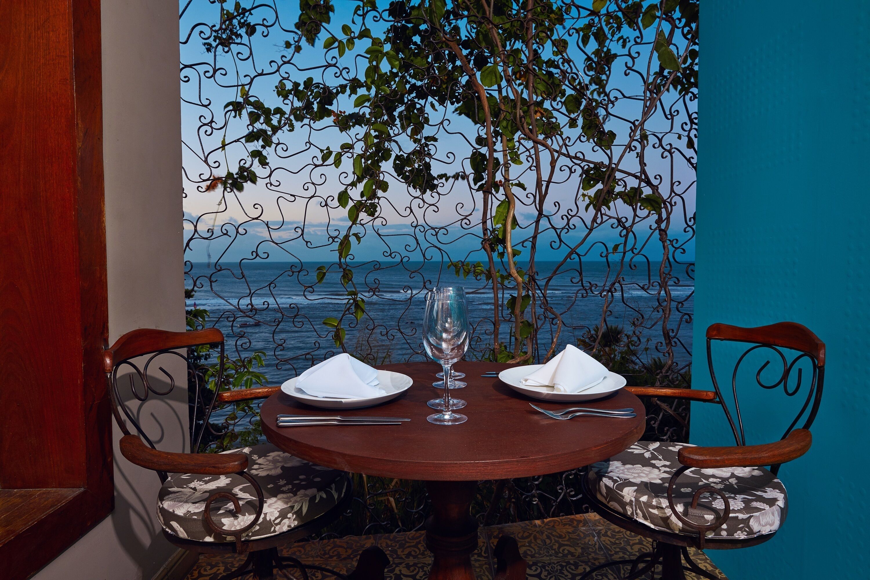 A table set for two with a view of the sea.