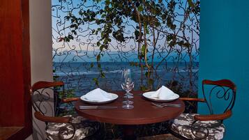 A table set for two with a view of the sea.