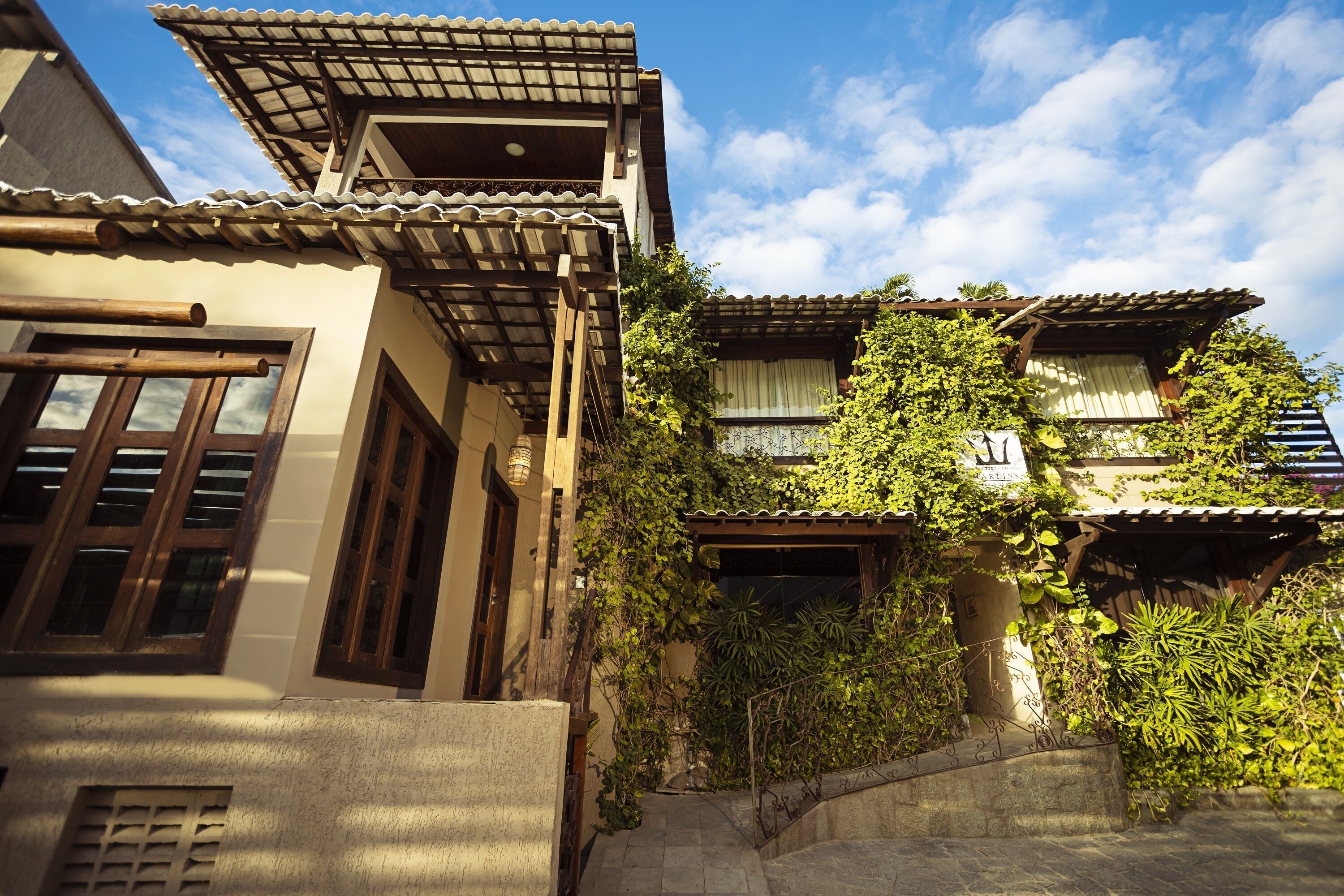 A traditional building with a tiled roof, wooden beams, and a stone pathway leading to the entrance.