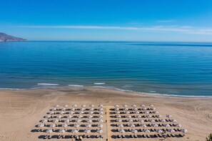 On the beach, beach cabanas, sun-loungers, beach umbrellas