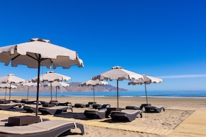 On the beach, beach cabanas, sun-loungers, beach umbrellas
