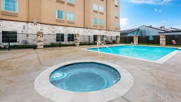 Seasonal outdoor pool, open 9:00 AM to 10:00 PM, pool umbrellas