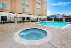 Seasonal outdoor pool, open 9:00 AM to 10:00 PM, pool umbrellas