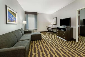 Premium bedding, desk, laptop workspace, blackout drapes