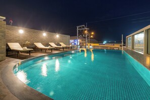 A swimming pool with lounge chairs and a modern architectural design. - Riche Hua Hin (Hua Hin)