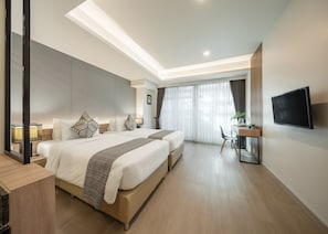 A modern hotel room with two beds, a desk, a TV, and a large window with curtains. - Nap in Chiangmai (Chiang Mai)