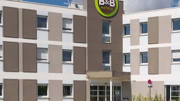 A B&B hotel with a modern facade, multiple windows, and a clear entrance.