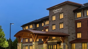 A multi-story hotel with a stone facade, a covered entrance, and a sign reading "HOMEWOOD SUITES by Hilton". - Homewood Suites by Hilton Burlington (South Burlington)