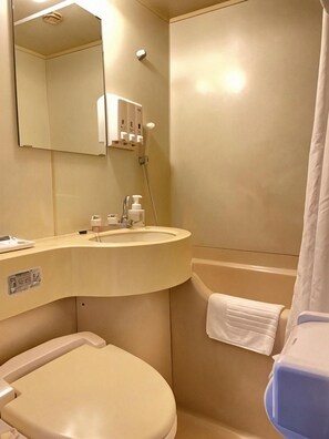 A bathroom with a toilet, sink, and shower area. - Marroad Inn Tokyo (Fuchu)