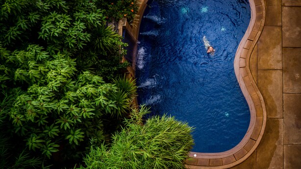 An aerial view of a swimming pool surrounded by lush greenery. - Robam Inn (Siem Reap)
