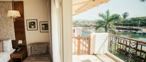 A balcony with a view of a marina and palm trees.