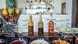 A buffet table with various food items and condiments.
