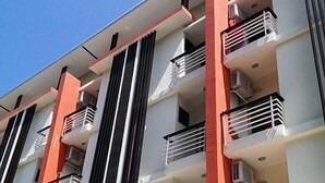 A multi-story building with balconies, air conditioning units, and a sign that reads "pascal gallery". - The Passion (Chiang Mai)
