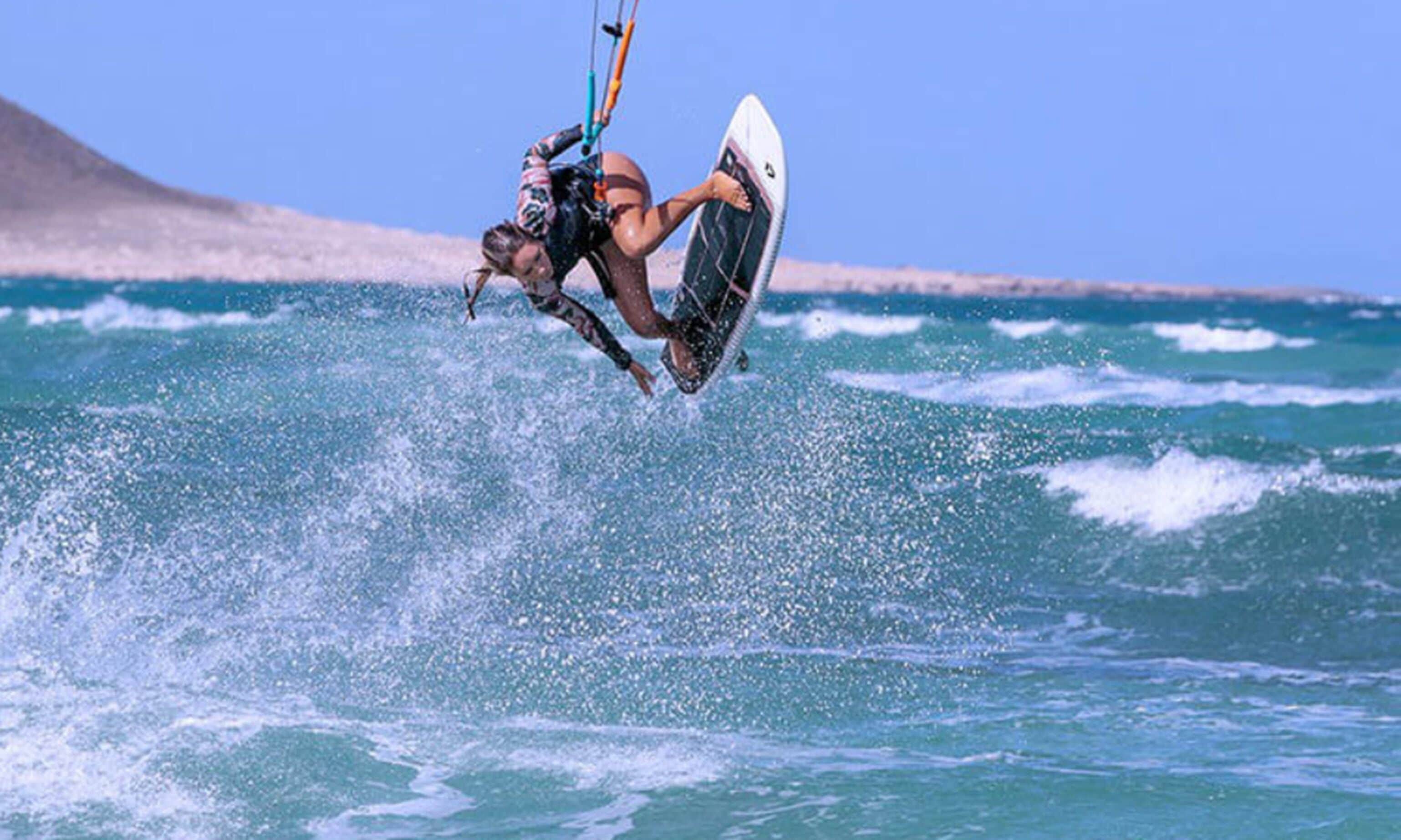 A person kiteboarding over the ocean.