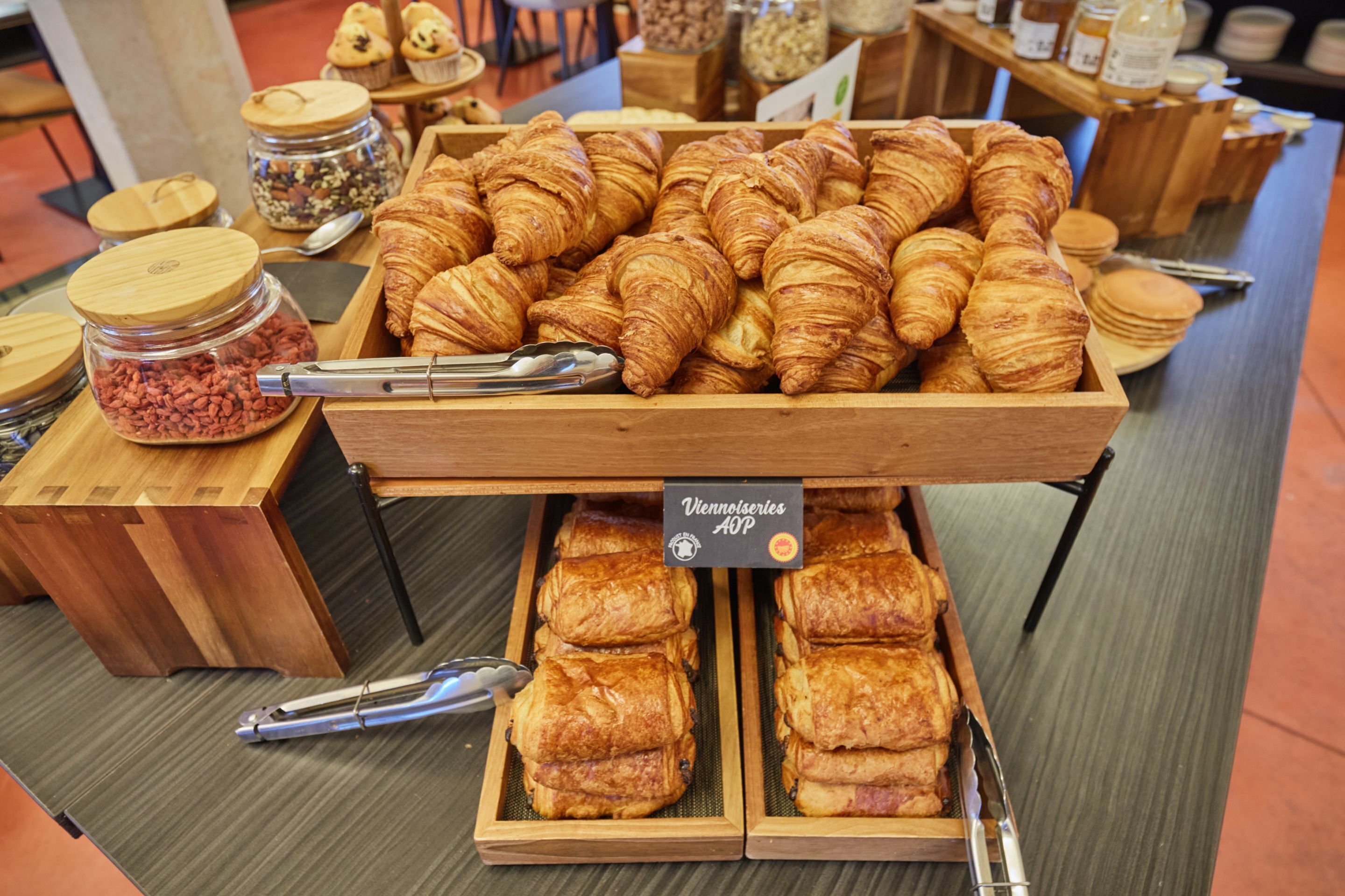 A display of assorted pastries and baked goods in a bakery setting.