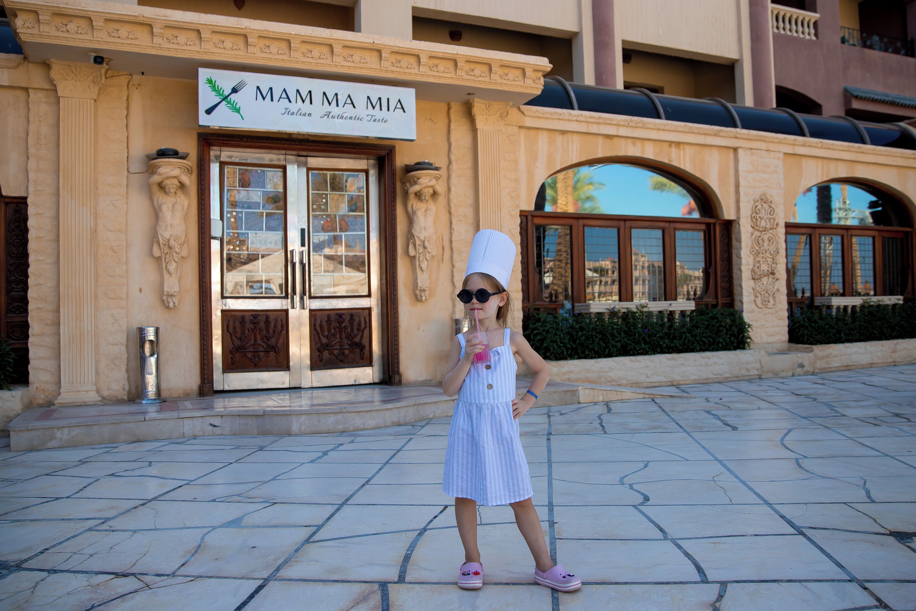 A building facade with a sign reading "MAMMA MIA Italian Authentic Taste."