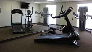 A gym with a treadmill, elliptical, and stationary bike. - Spark by Hilton Odessa (Odessa)