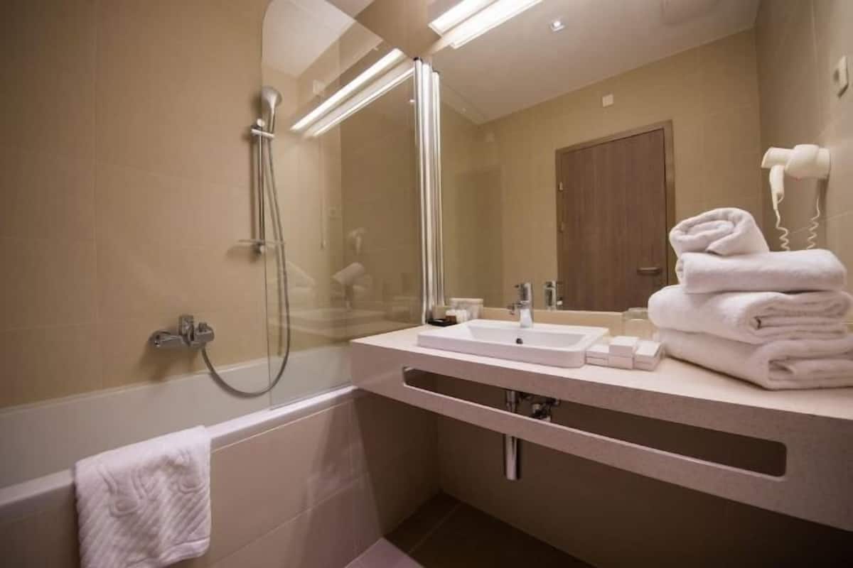 Bathroom | Designer toiletries, hair dryer, slippers, towels