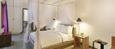 A bedroom with a four-poster canopy bed, bedside tables, a nightstand, and a wardrobe.