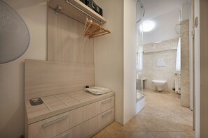 A modern bathroom with a wooden vanity, a towel rack, and a shower area. - Boutique Residence by Little King (Prague)