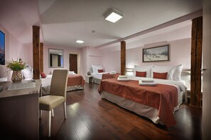 Quadruple Room | Minibar, in-room safe, individually decorated, individually furnished