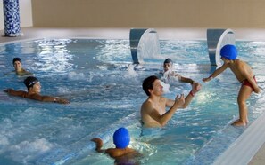 Piscina com pessoas praticando atividades aquáticas.
