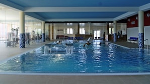 An indoor swimming pool with multiple lanes, a water slide, and exercise equipment. - Palace Hotel & Spa Termas de S. Miguel (Fornos de Algodres)